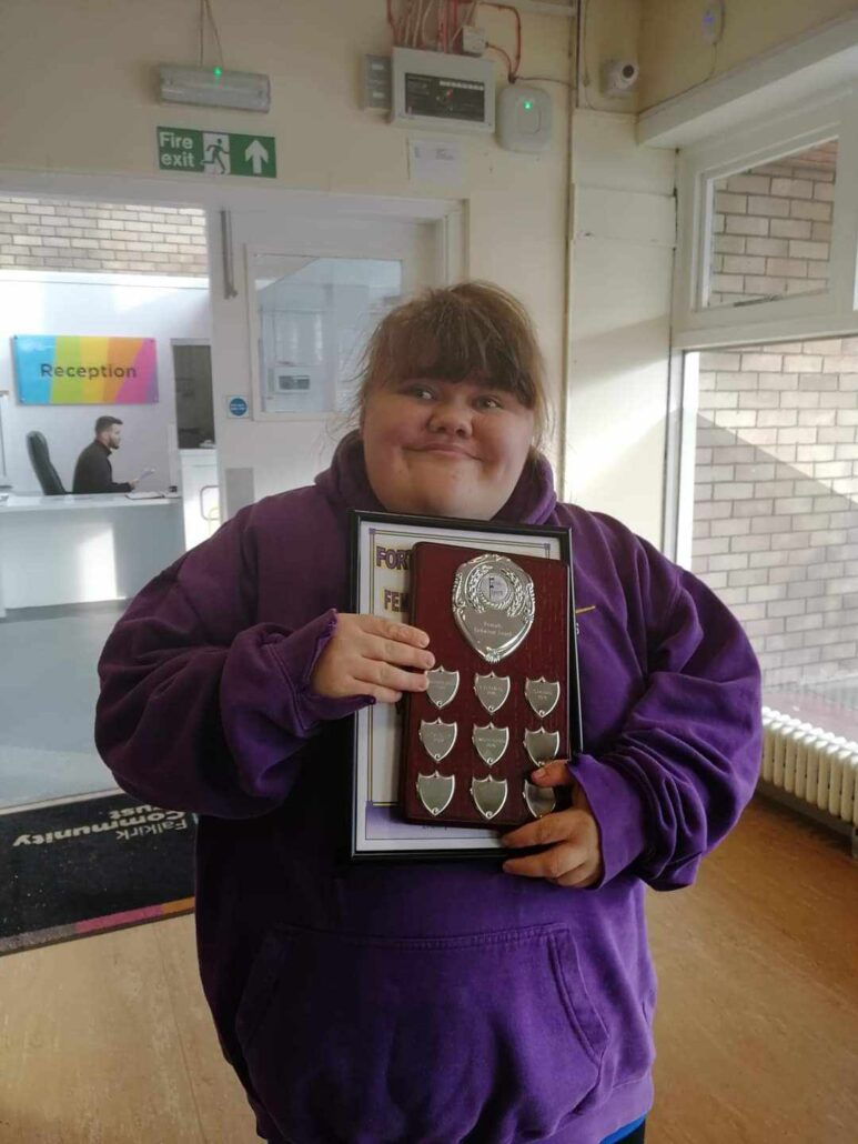 Proudly holding her medal plaque