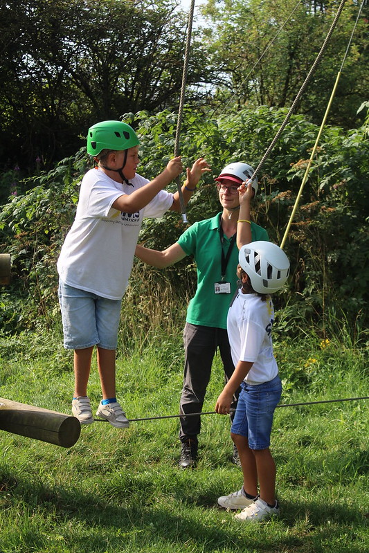 Theo is encouraged on the low ropes by his brother Marty at SMS Foundation activity weekend