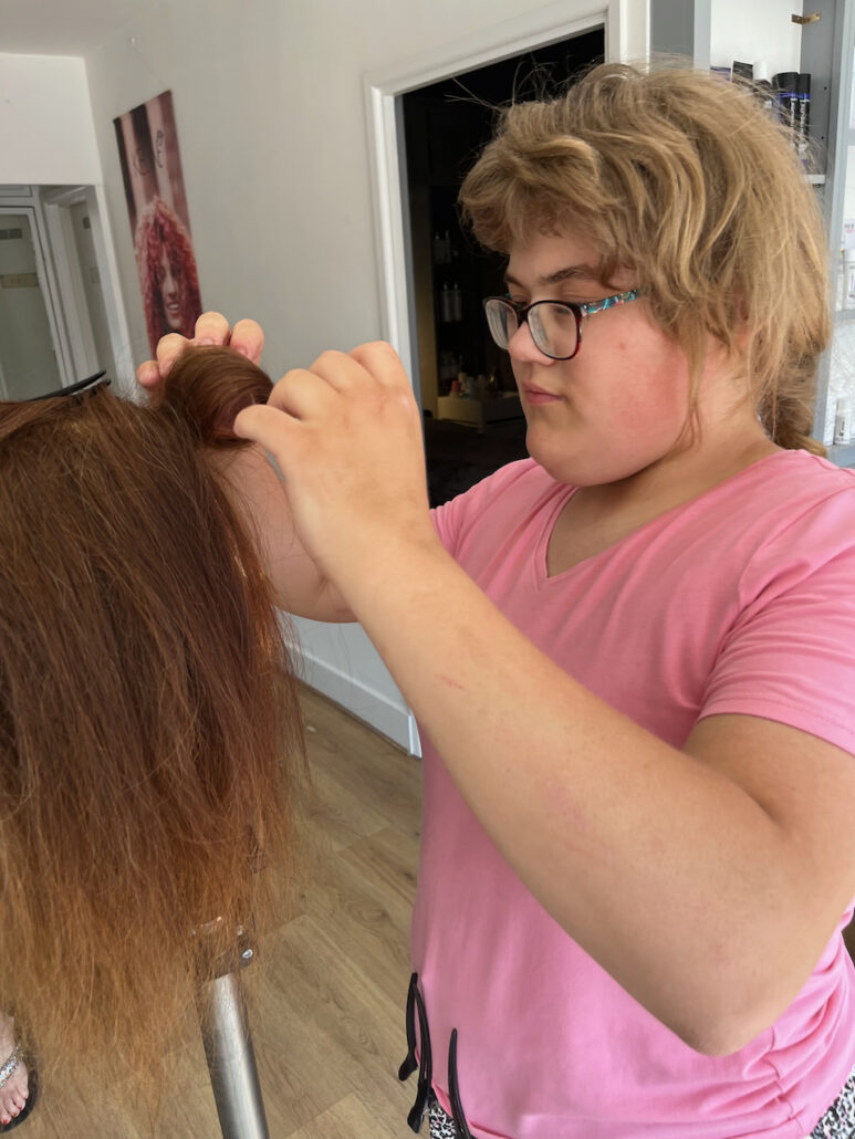 Putting rollers into the mannequin's hair